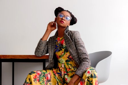 Woman Sitting On Chair While Leaning On Table photo