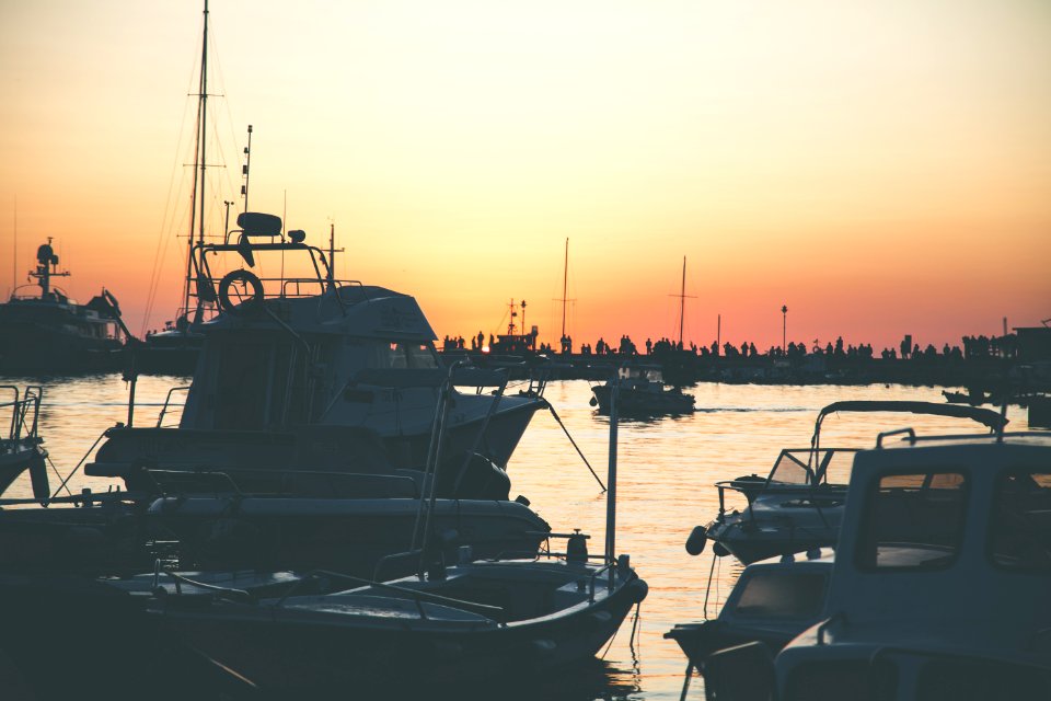 Several Boats On Calm Water During Golden Hour