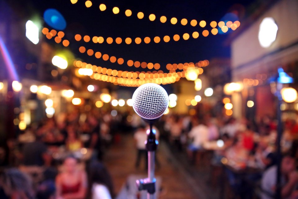 Selective Focus Photo Of A Microphone In Front Of Audience photo