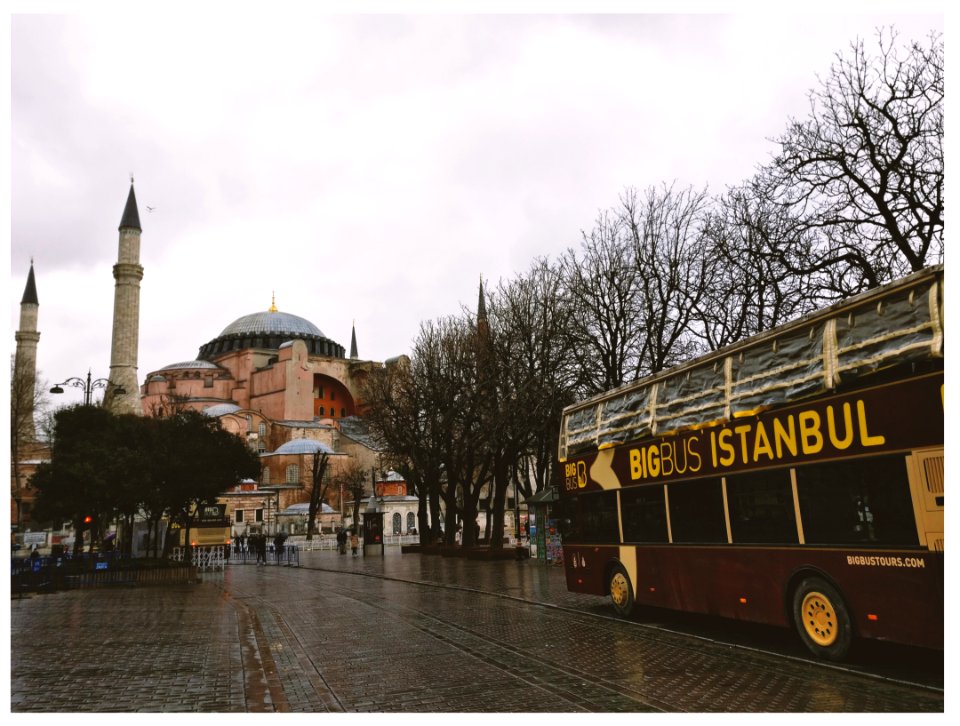Brown Bigbus Istanbul Traveling On Road Near Brown Dome Building