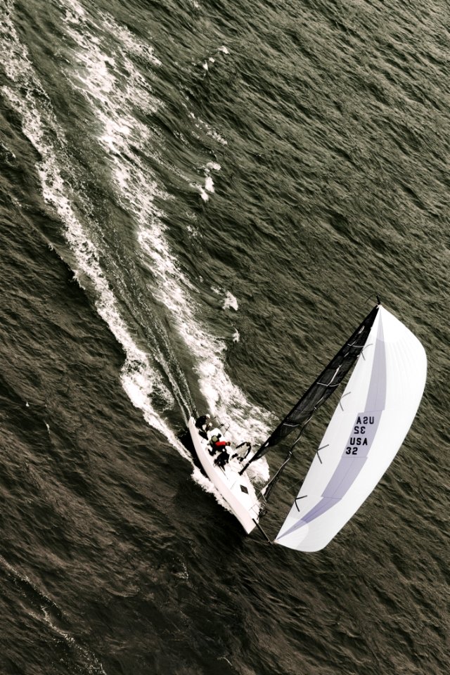 People Riding On White Sailboat On Body Of Water