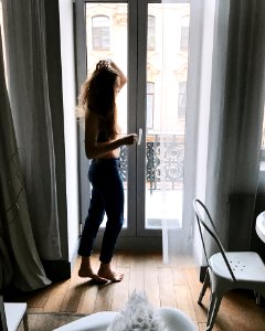 Photo Of Woman In Blue Pants Holding Her Hair photo