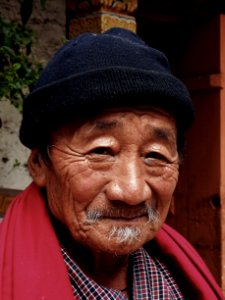 Smiling Man Wearing Red Scarf And Black Beanie photo