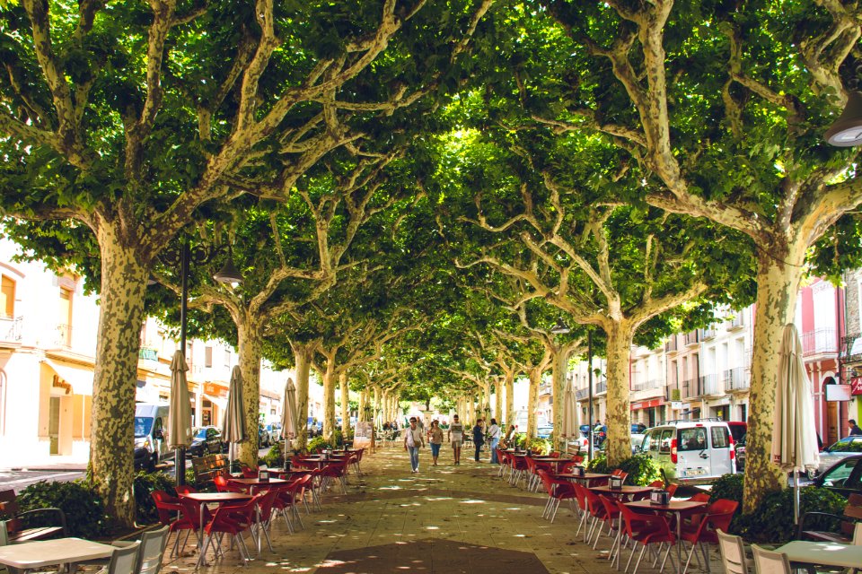 Red Wooden Table With Chairs On Street