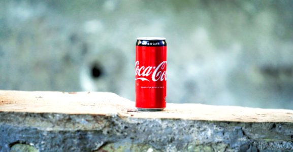 Coca-cola Can On Brown Concrete Surface photo