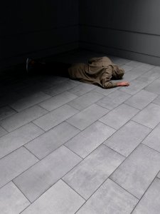 Person Wearing Grey Hoodie And Black Jeans Laying On Floor photo