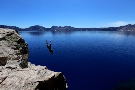 Photo Of Man Diving In To Water photo