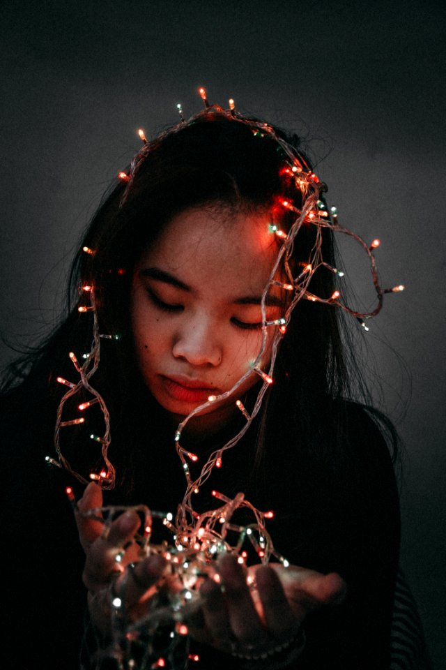 Woman Wears Black Long-sleeved Shirt Hold String Lights