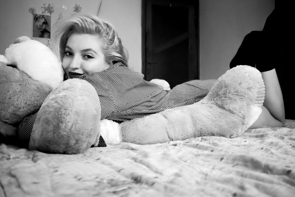 Woman Hugging Bear Lying On Bed