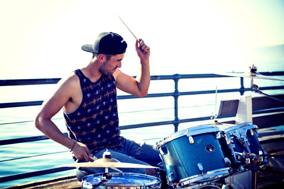 Man Playing Drum Near Bay At Day Time