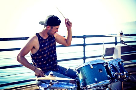 Man Playing Drum Near Bay At Day Time photo