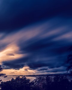 City Beside Sea Under Cloudy Sky photo