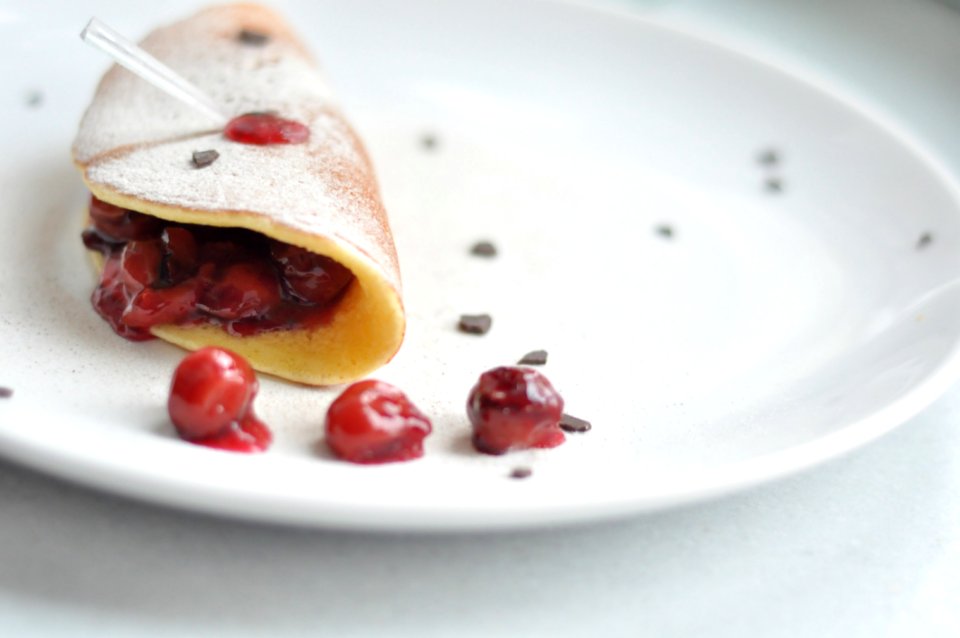 Cherry Crepe Dish On Round White Ceramic Plate photo