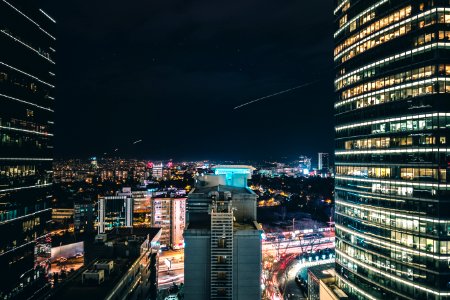 High Rise City Building During Night Time Photo photo