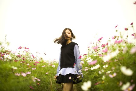 Woman Standing In The Flower Field