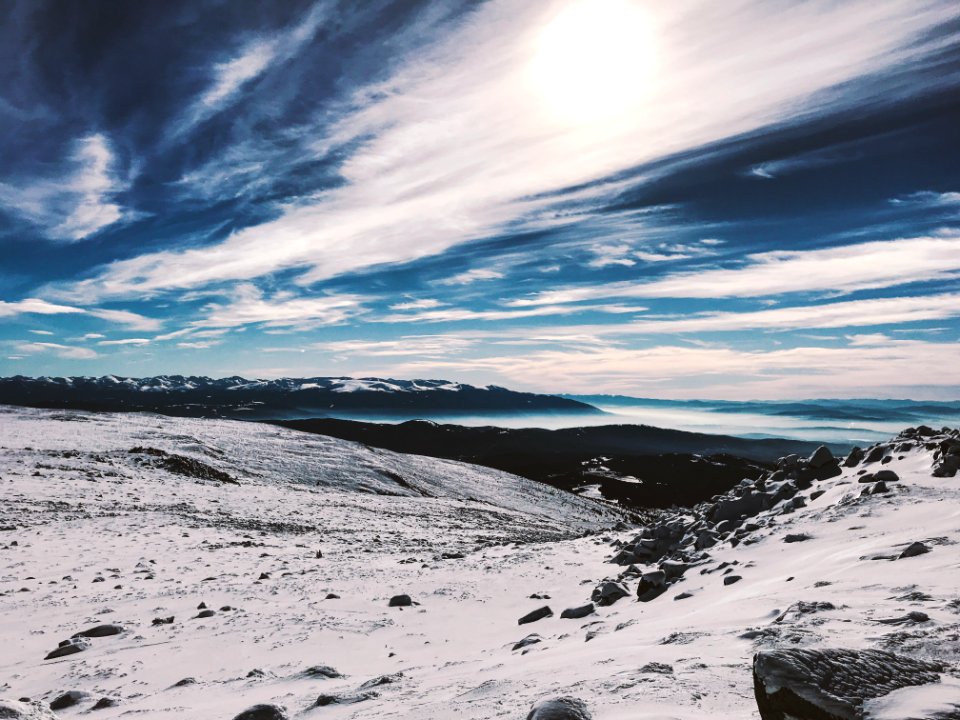 Snow Covered Hill Under Cloudy Blue Sky