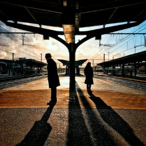 Man And Woman Silhouette Standing On Brown Ground At Daytime photo