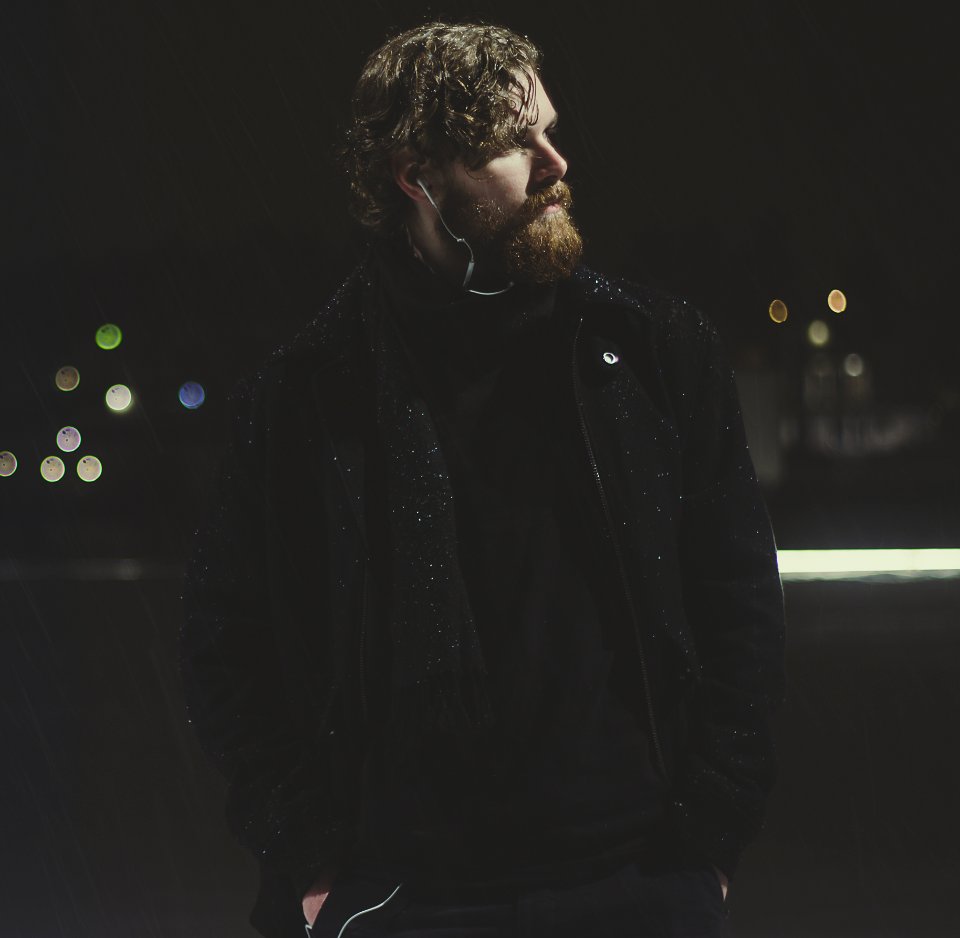 Man Wearing Black Zip-up Jacket Taking Picture During Nighttime