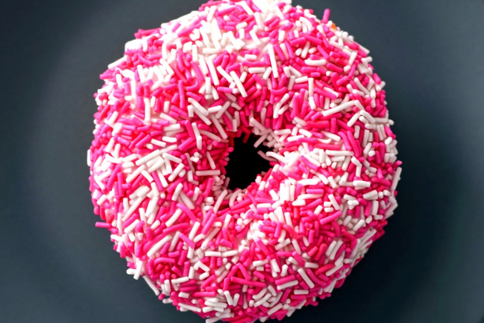 Doughnut With White And Pink Sprinkles
