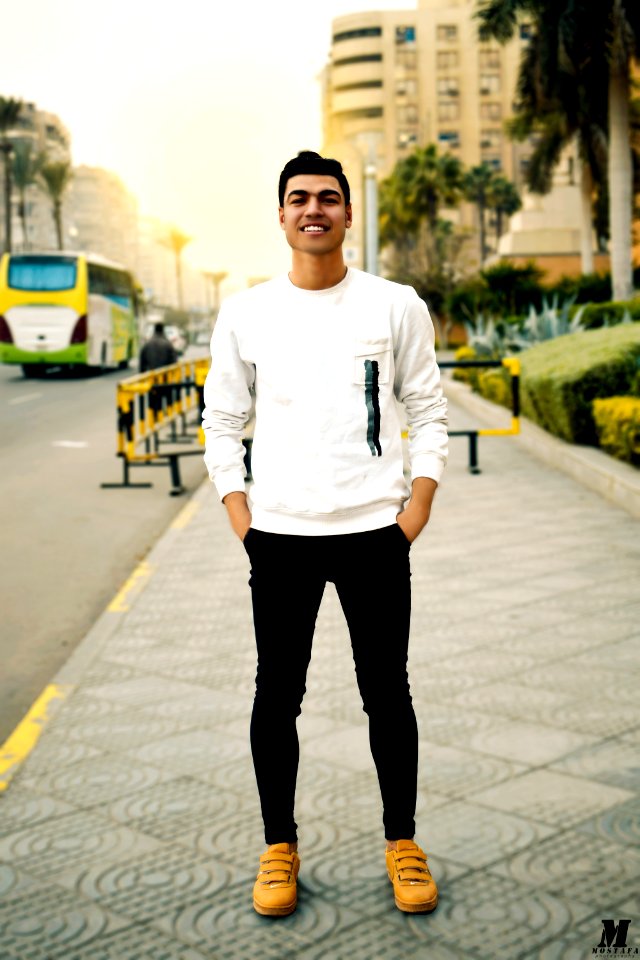 Man In White Crew-neck Sweater Taking Selfie Beside Street Road