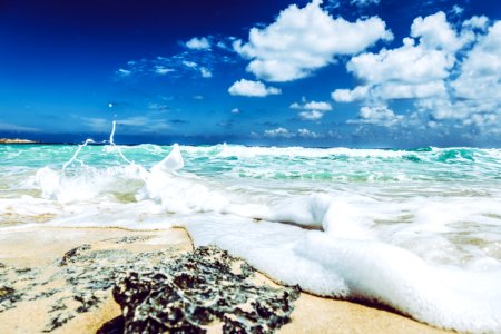 Landscape Photography Of Beach With Raging Waves Under Clear Skies photo