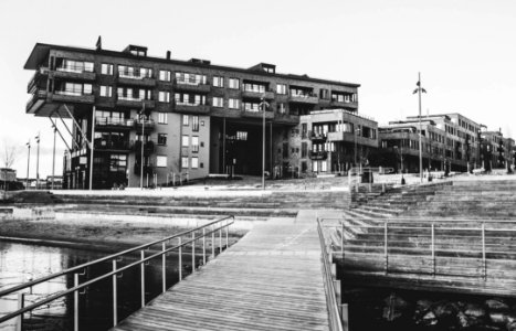 Gray Scale Photo Of A Dock Near A Building photo