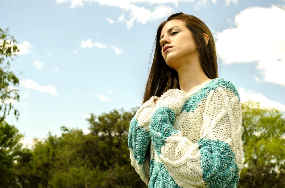 Woman In White And Teal Crochet Dress Under Cloudy Sky