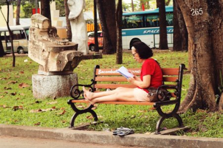 Woman In Red Shirt Sitting On Bench photo