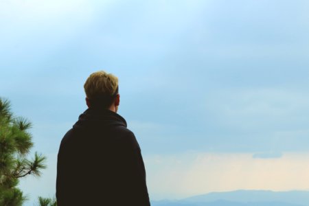 Man Wearing Black Jacket Standing Near Tree photo