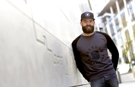 Man Leaning Against The White Concrete Wall