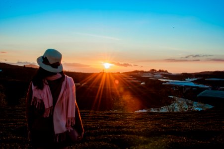 Person Wearing White Fedora Hat And Pink Scarf During Golden Hour