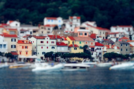 Tilt Shift Lens Photography Of Red Roof House Near The Body Of Water photo