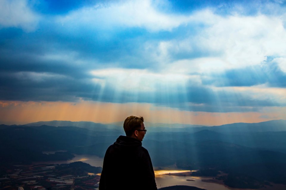 Man Wearing Black Jacket Above The Mountain