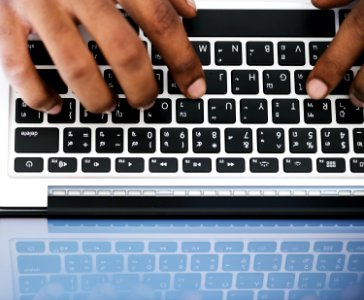 Person Typing On White And Black Laptop Computer