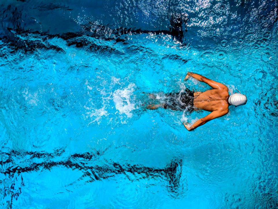 Person Swimming On Body Of Water