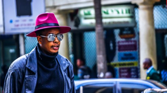 Man Wearing Purple Hat And Black Leather Jacket photo