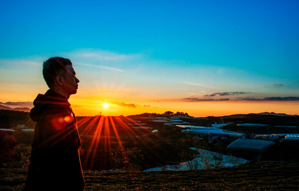Photo Of A Man Wearing Hoodie During Sunset