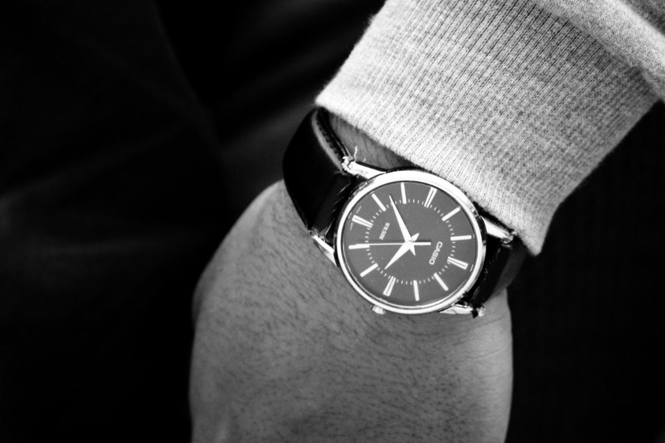 Person Wearing Round Silver Analog Watch With Black Leather Strap photo