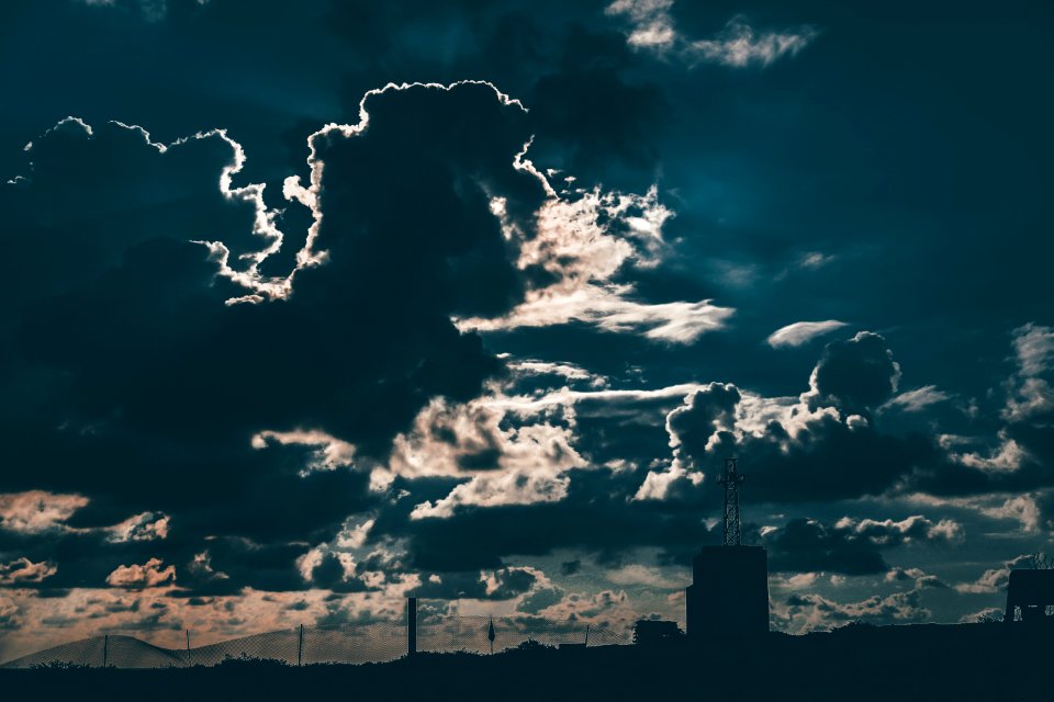 Silhouette Of Building Under Cloudy Blue Sky