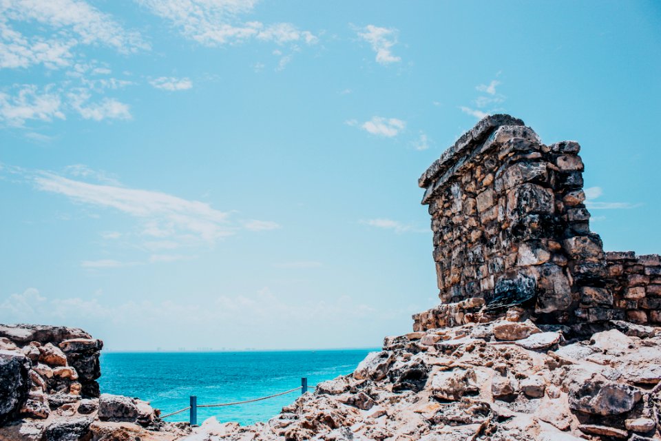 Rocky Terrain Near Sea Under Blue Skies photo