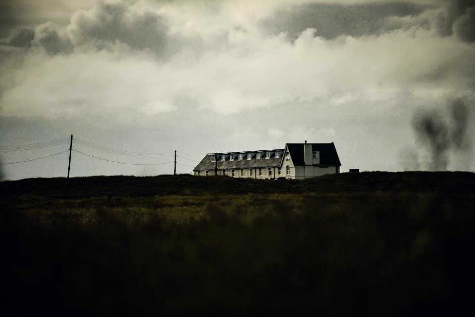 White Concrete House Under White Clouds