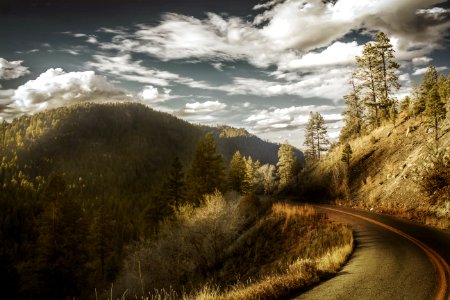 Curved Asphalt Road Between Mountains photo