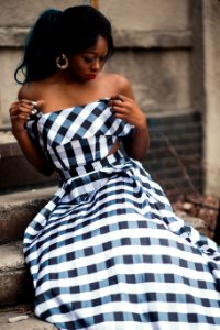 Woman Wearing Strapless Dress Sitting On Staircase