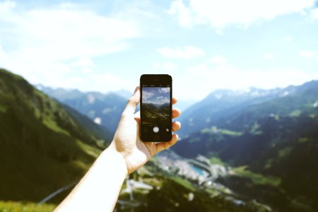 Person Holding Space Gray Iphone 5s Taking Picture Of Mountains