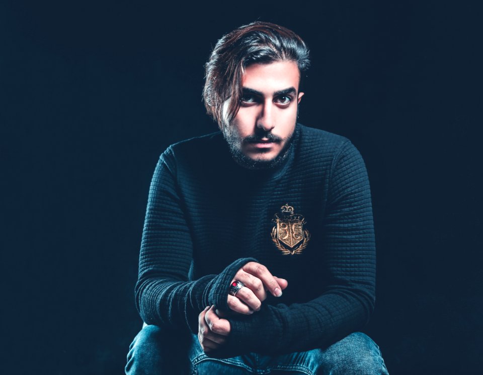 Man Wearing Black Sweater Holding His Hand