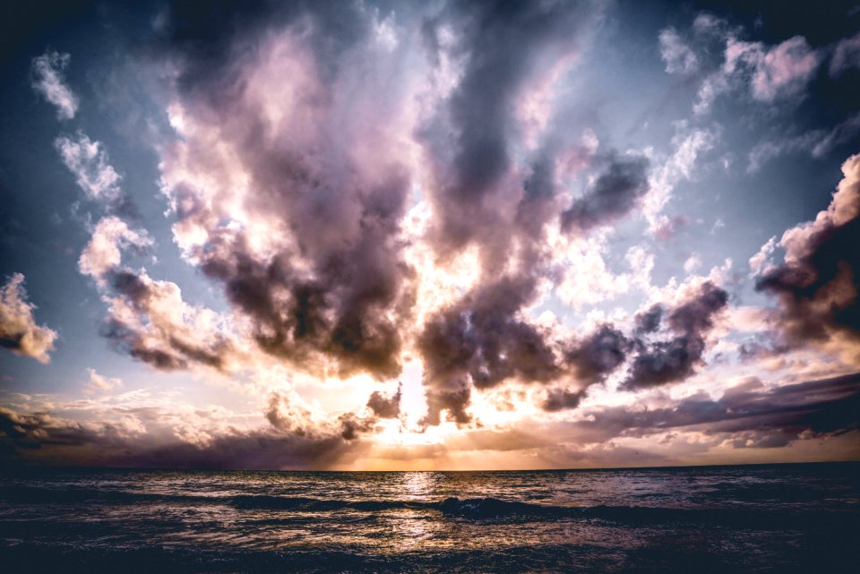 Calm Body Of Water With Cloudy Skies