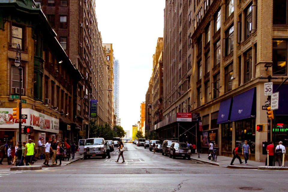 People Walking On Alley Surrounded By High Rise Buildings photo