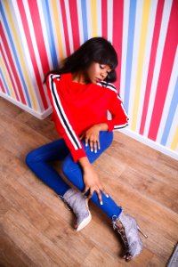 Woman With Red Long-sleeved Shirt Sitting On The Floor Looking Down photo