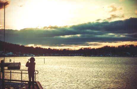 Silhouette Of Person Standing On Dock photo