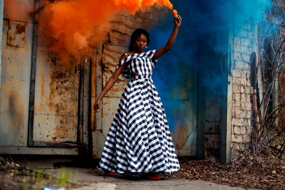 Woman In Black And White Plaid Dress Holding Torch